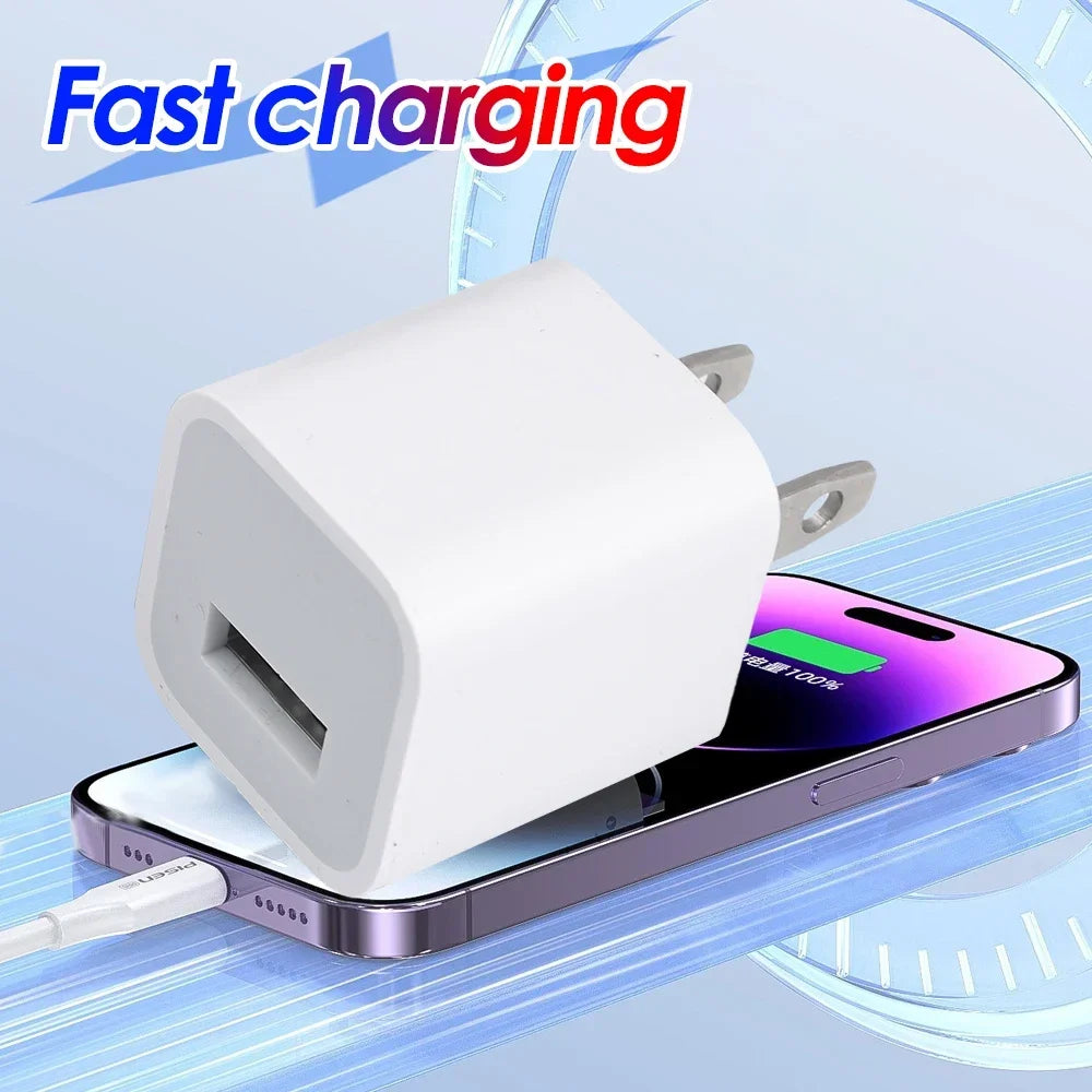 A white cube shaped universal USB wall charger is shown being used to charge a smartphone.