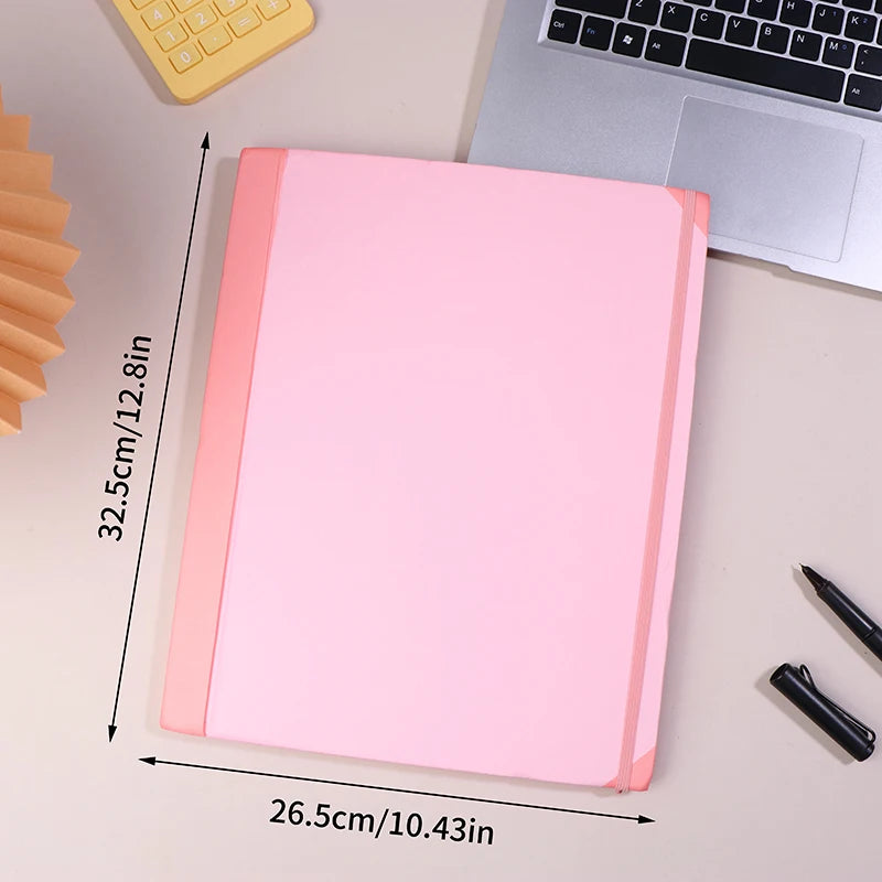A pink expanding accordion document organizer file folder next to a laptop and a yellow keyboard.