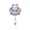 A cute cat charm on an acrylic nurse badge reel with a pink and white design.