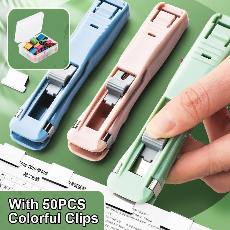 A hand is shown using a pink handheld binder clip pusher with green refill clips, next to a box of colorful clips.