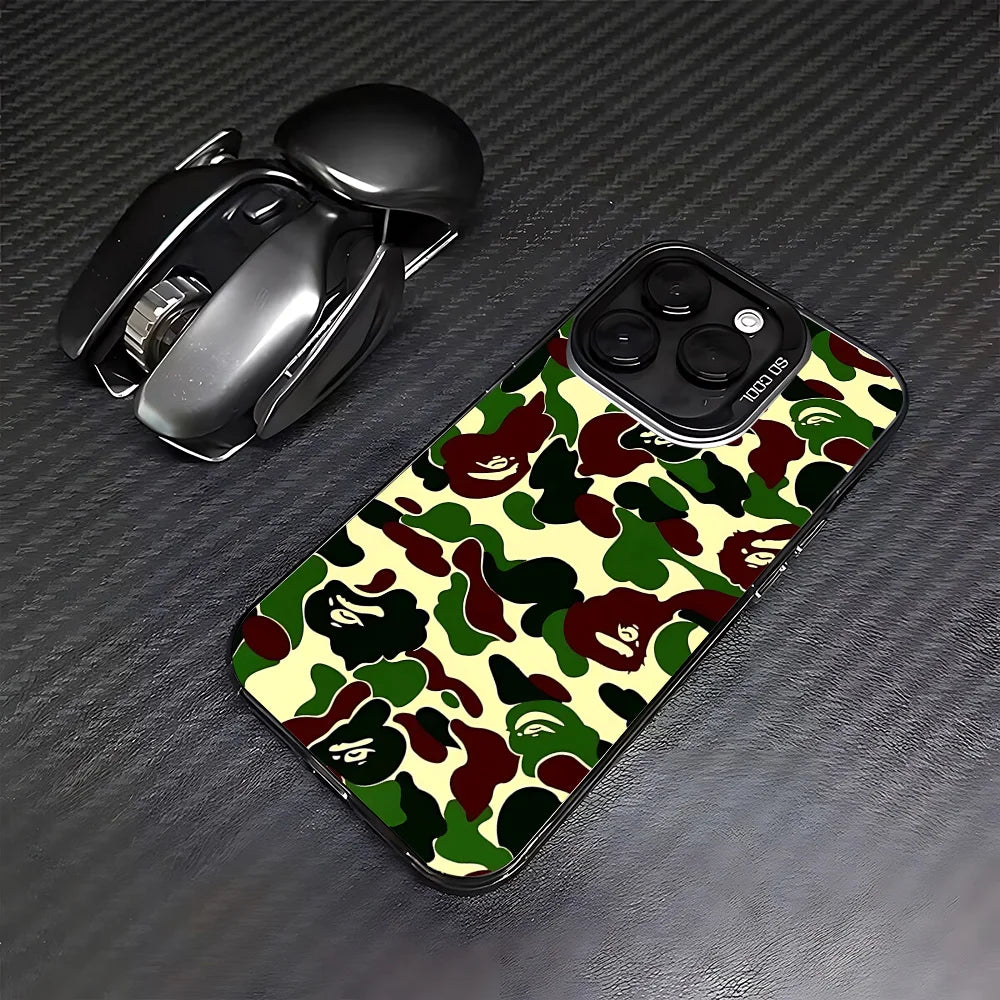 A black iPhone case featuring a leopard print camouflage pattern, placed next to a silver phone grip.