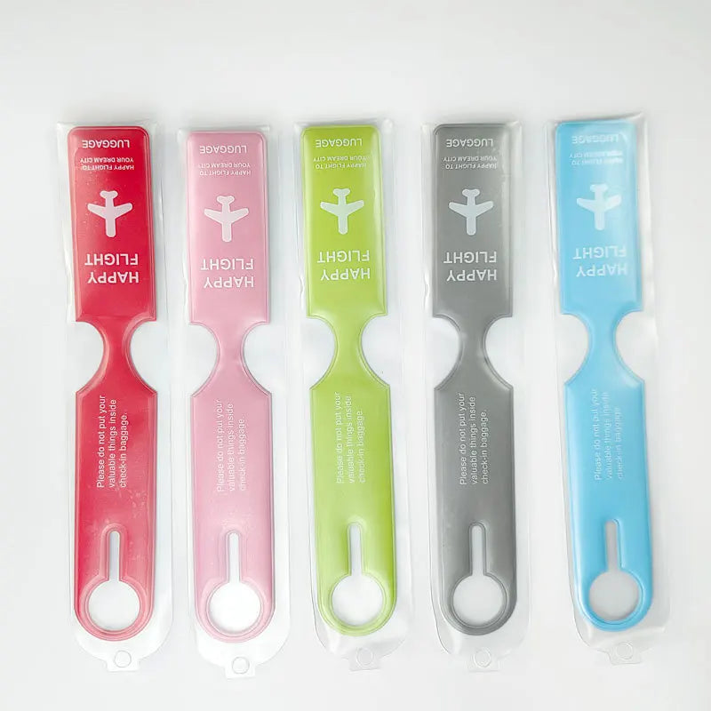 Five colorful durable PVC luggage tags in red, pink, lime green, gray, and blue.