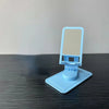 A light blue desktop stand for a phone or tablet with a mesh screen, resting on a dark surface.