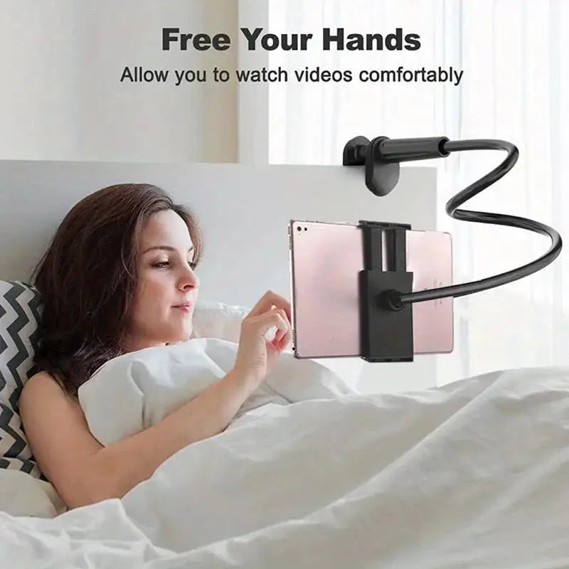 A woman is comfortably watching videos in bed using a flexible gooseneck clamp to hold her tablet or phone.