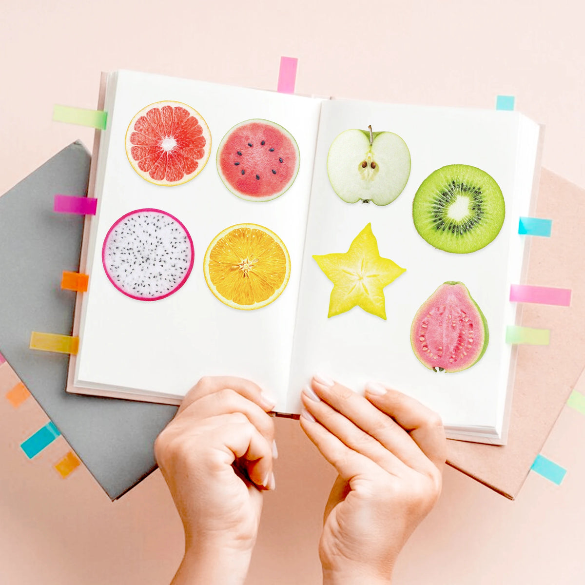 A set of fruit-shaped sticky notes including watermelon, grapefruit, orange, and kiwi slices on a white pad.