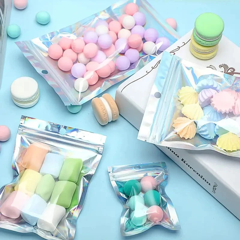 Assortment of pink and purple spherical candies packaged in holographic resealable mylar bags
