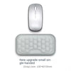 A small gray silicone wrist rest pad for an ergonomic keyboard and mouse.