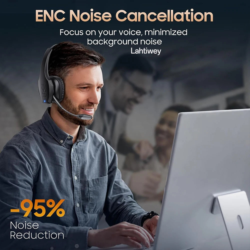 A man wearing a gray shirt is using an ENC noise cancellation headset while working on a laptop.