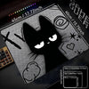 A black cat silhouette design on a mouse pad with a non-slip rubber base.