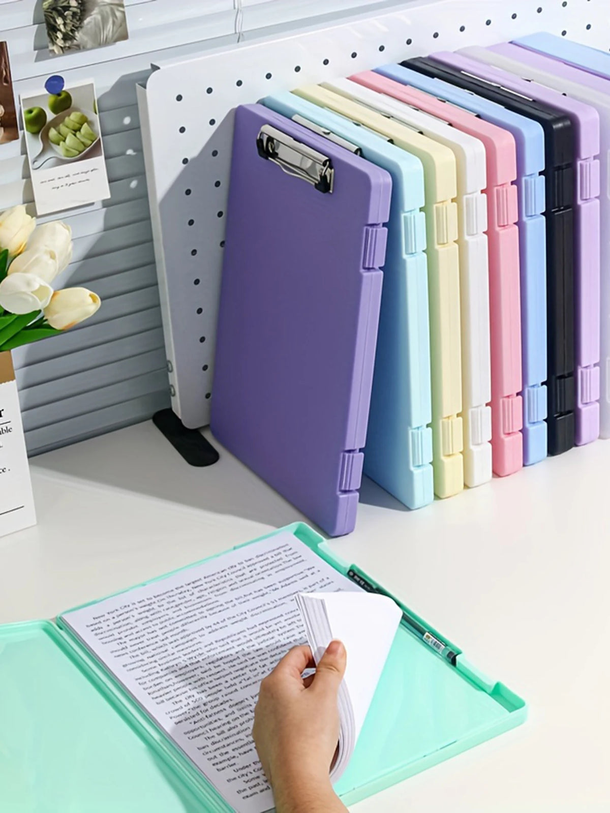 A collection of colorful A4 document and photo storage file boxes lined up on a white desk.