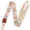 A beige patterned fashion lanyard strap with a gold clasp.