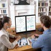 A woman and a man are looking at a laptop displaying data on a 14-inch dual screen portable monitor.