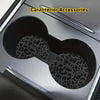 Two leopard print non-slip leather coasters are shown inside a car interior accessory cup holder.