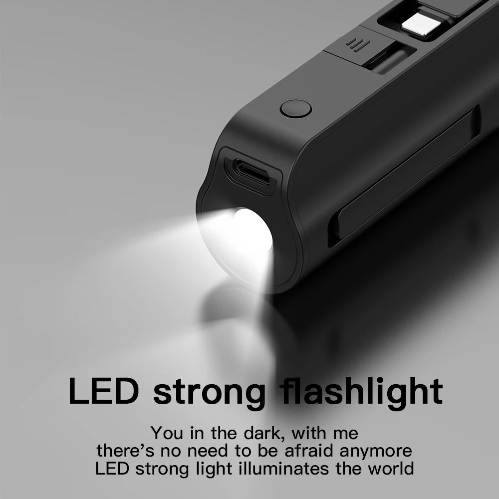 A black portable power bank with an LED flashlight illuminating a surface.