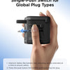 A hand is using a single-push switch adapter to connect a plug, demonstrating its use for global plug types.