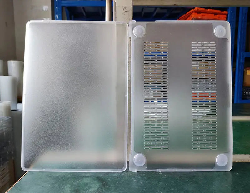 A clear, silver-colored hard shell laptop case for a MacBook Neo 13 is shown, displaying various ventilation patterns.