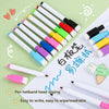 A set of eight colored dry erase markers with magnetic erasers laid out on a white surface.