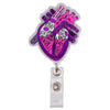 A silver badge reel featuring a detailed anatomical diagram of the heart.