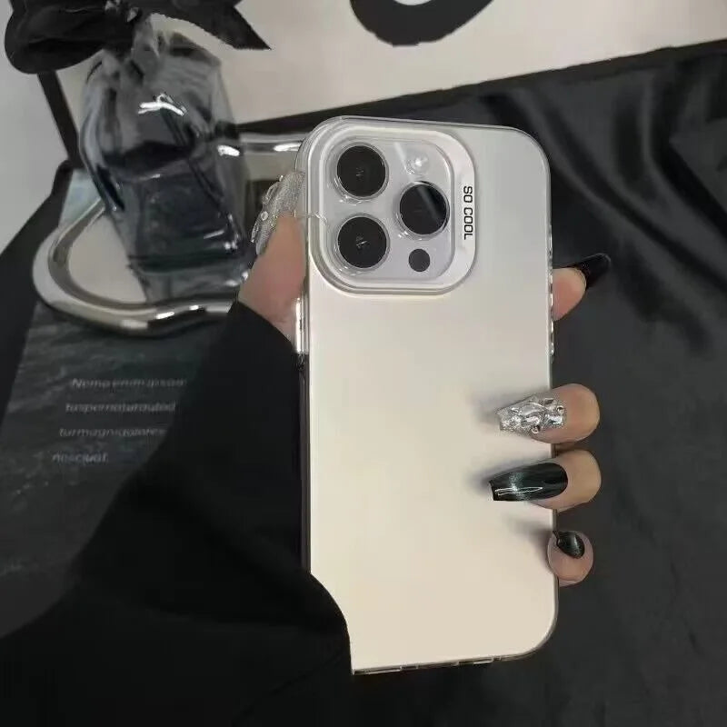 A hand holds a white phone case with a clear back, displaying multiple camera lenses against a dark background.