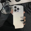 A hand holds a white phone case with a clear silicone grip and multiple camera lenses against a dark background.