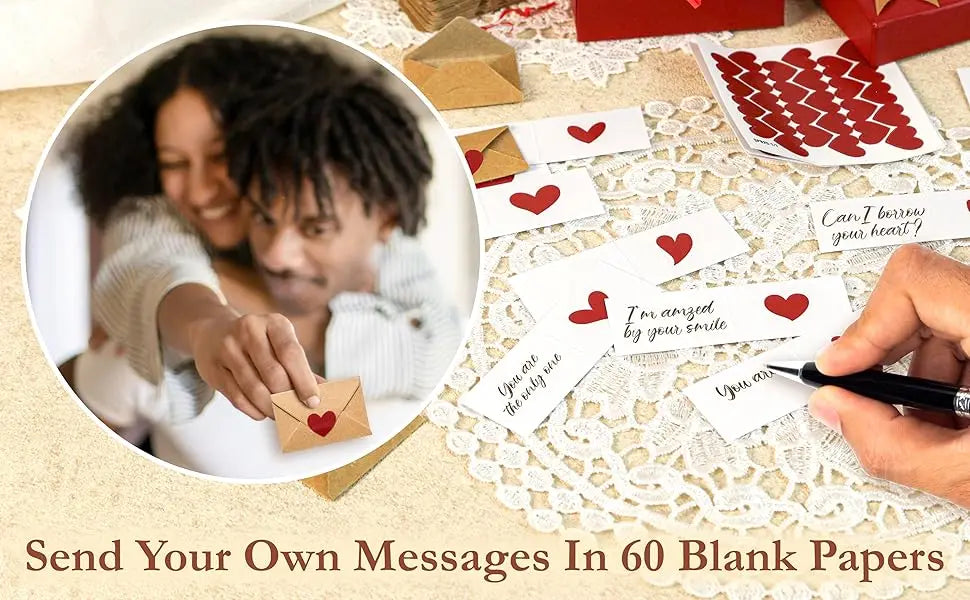 A hand writes a message on a blank note card placed on a lace surface with red envelopes nearby.