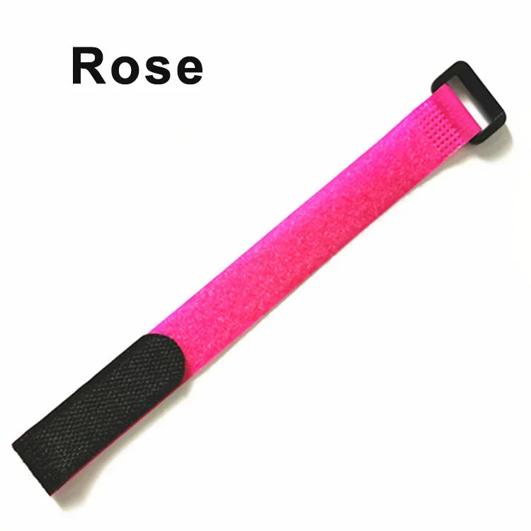 A bright pink hook and loop cable tie with a black grip and plastic clip.