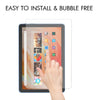 A hand is applying a tempered glass screen protector to an Apple Fire HD 10 tablet.