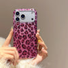 A hand holds a glamorous leopard print sequin shockproof phone case for an iPhone against a neutral background.