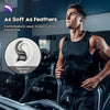 A man wearing black athletic gear is shown in a gym setting, demonstrating the ergonomic design of Bluetooth ear hooks with a