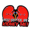 Red kidney shaped enamel pin featuring a cute face design.