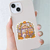 A hand holds a phone displaying a pastel Halloween sticker pack featuring cute ghost, pumpkin, and dessert vinyl decals.
