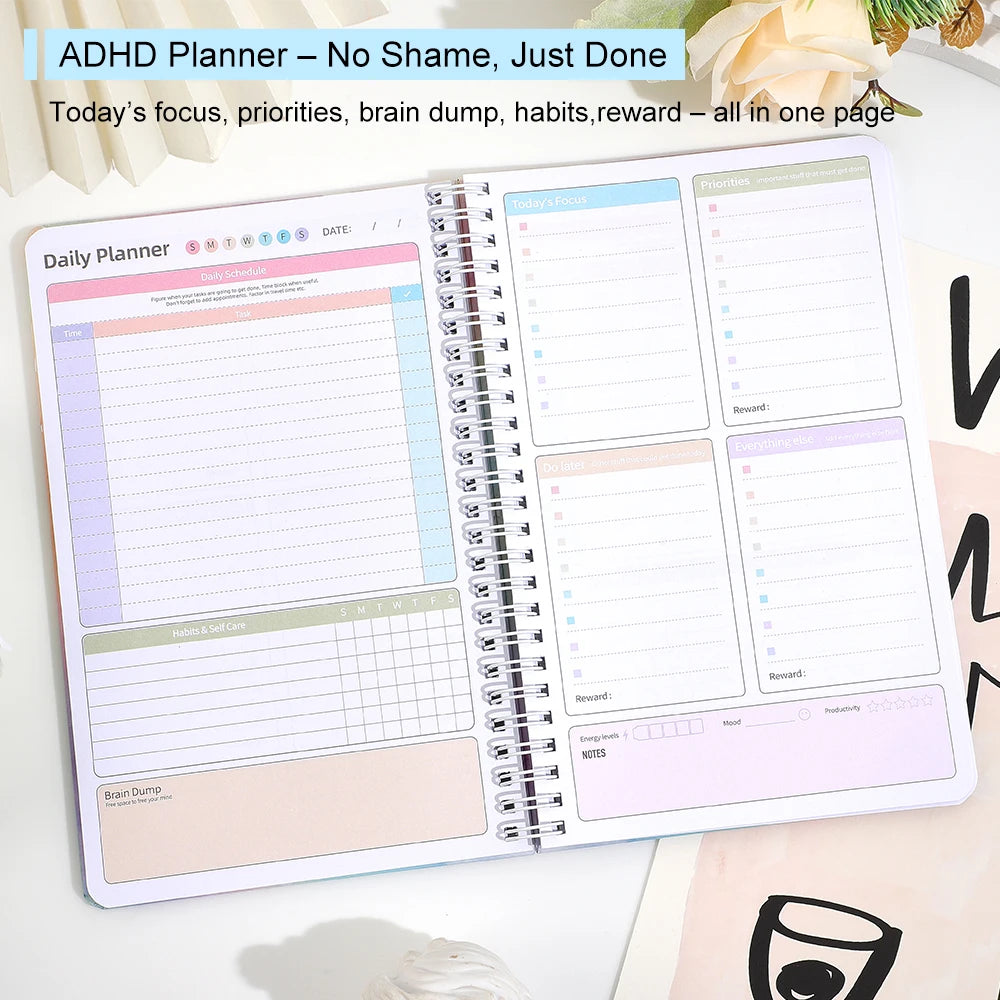 An open ADHD Daily Planner notebook showing pages for focus, priorities, habits, and reward tracking.