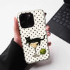 A black cat martini pattern hybrid phone case is held in a hand against a white background.
