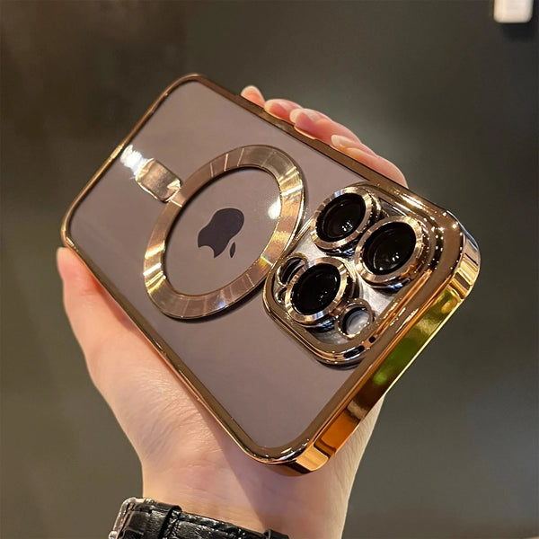 A hand holds a gold-plated magnetic clear case for a smartphone, showing the back of a MagSafe iPhone.