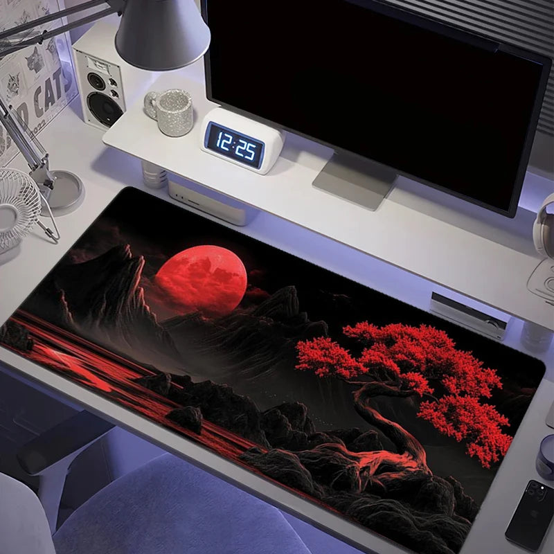 A large silicone gaming mouse pad featuring a dramatic red moon landscape and dark terrain.