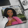 A glossy photo of a doll face is printed on a mouse pad with a non-slip rubber base.