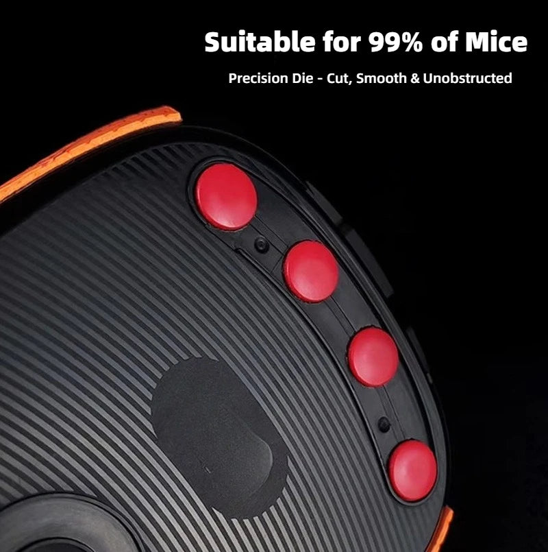 Close-up view of a black PTFE mouse skate with red adhesive dots on the top surface.