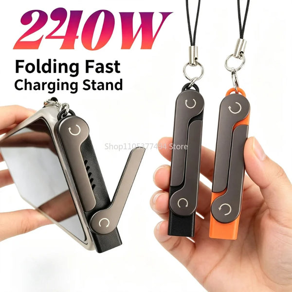 A hand holds a folding fast charging stand with an adapter and phone holder in black, gray, and orange colors.