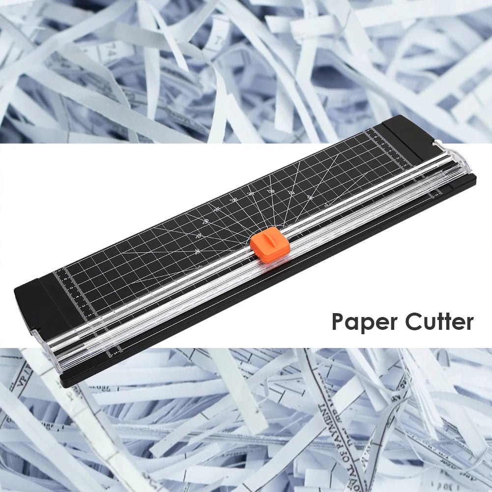 A black paper cutter with an orange blade is shown against a background of shredded white paper.