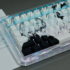 A close-up view of a custom PBT cherry profile keycap set featuring Kaneki Ken anime designs, illuminated by blue lighting.