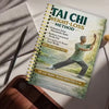 A spiral-bound manual titled Tai Chi Weight-Loss Method for a 28-day body transformation plan is shown on a wooden surface.