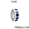 A roll of round dot labels with a silver background and dark blue dots for organization.