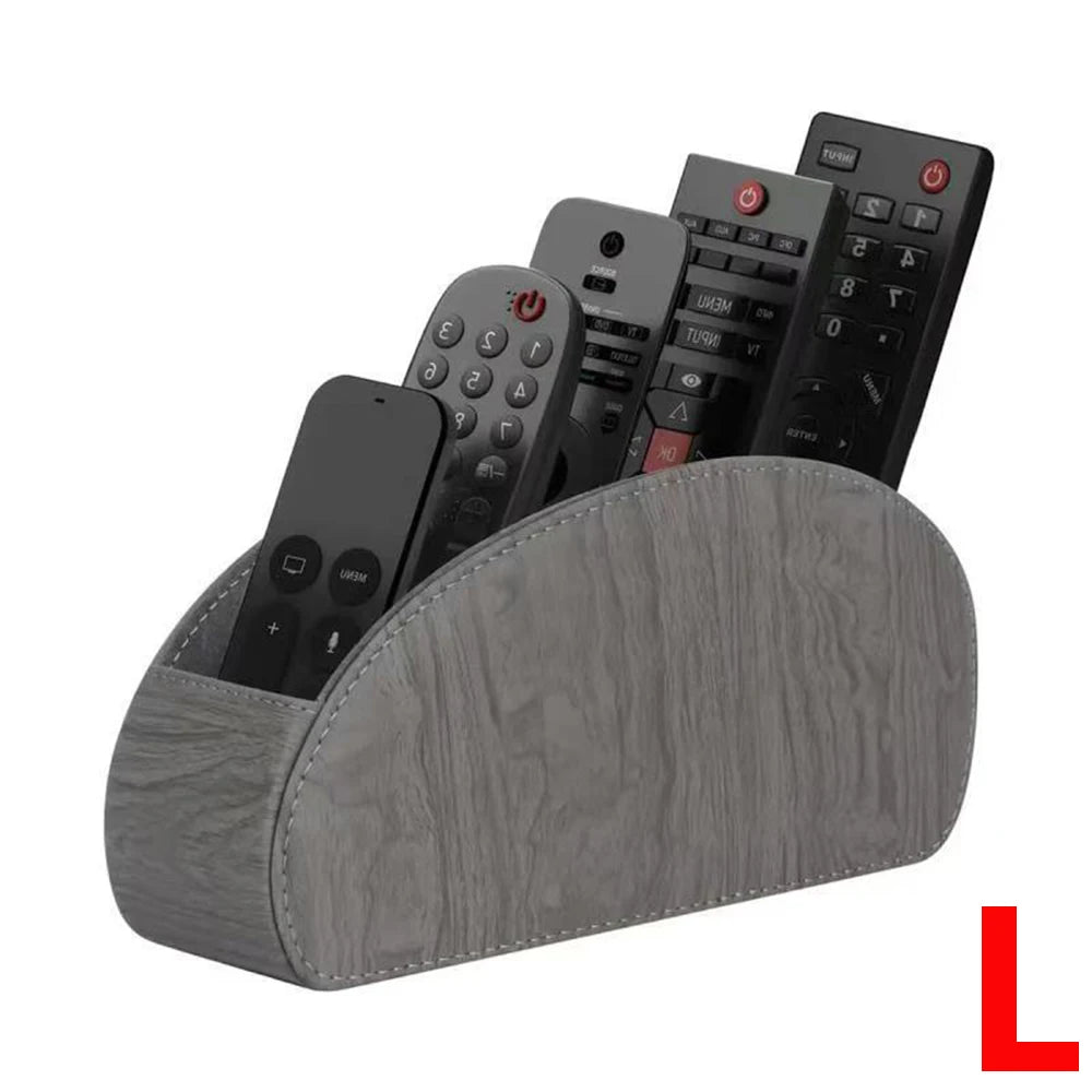 A grey PU leather remote control holder with five compartments displaying various electronic devices.