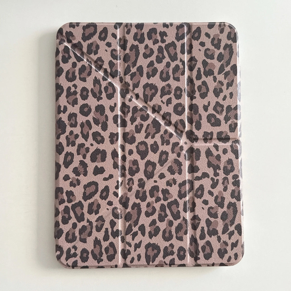 A protective leather case for an iPad featuring a brown and black leopard print pattern.