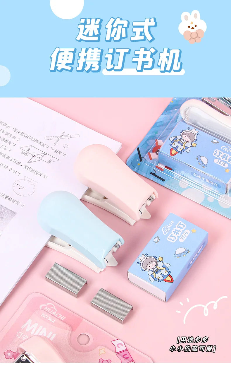 A collection of pink and blue cartoon mini staplers for students and office use displayed on a light pink background.