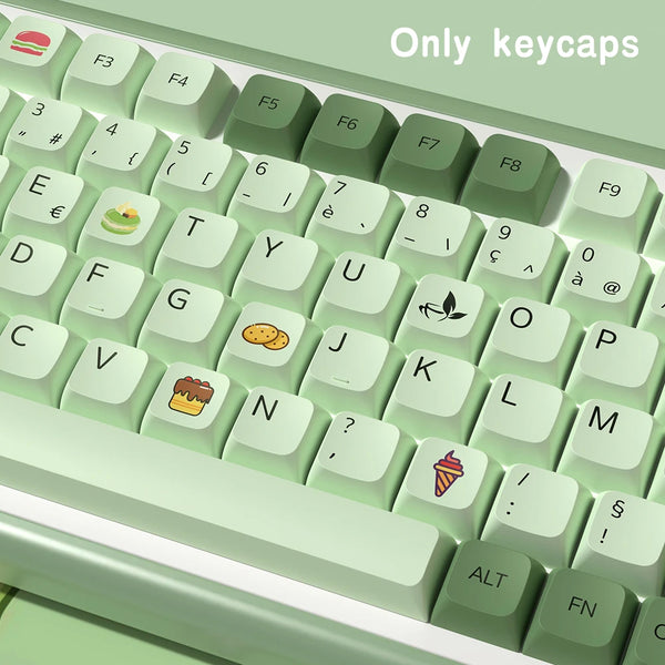 A close-up view of light green PBT keycaps for a mechanical keyboard, showing various letter and symbol keys.