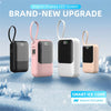 Four pink and white digital display LED screen power banks with carrying loops displayed on a snowy surface.