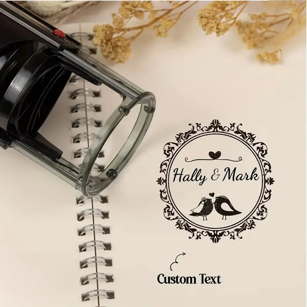 A black self-inking stamp is shown resting on a spiral notebook page, with a circular logo for 'Hally & Mark' and space for c