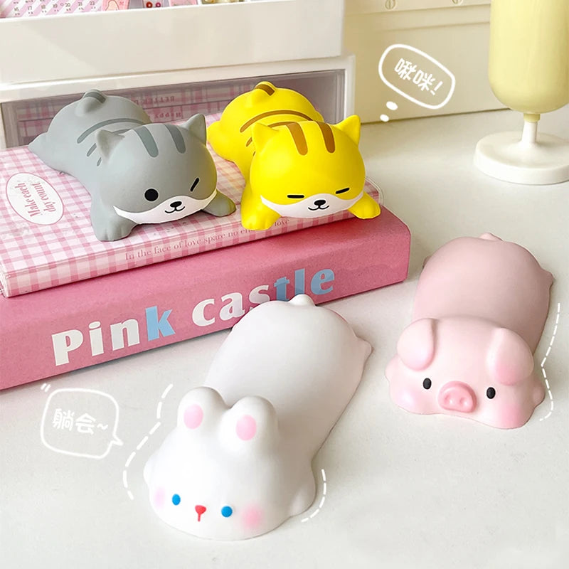 A set of pink and gray kawaii ergonomic wrist rests shaped like cats and a pig for mouse and keyboard use.