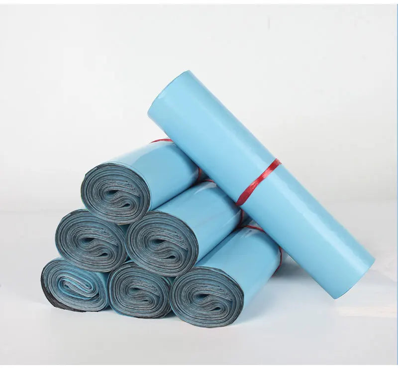 A roll of light blue reusable waterproof poly shipping bags, shown diagonally on a white background.
